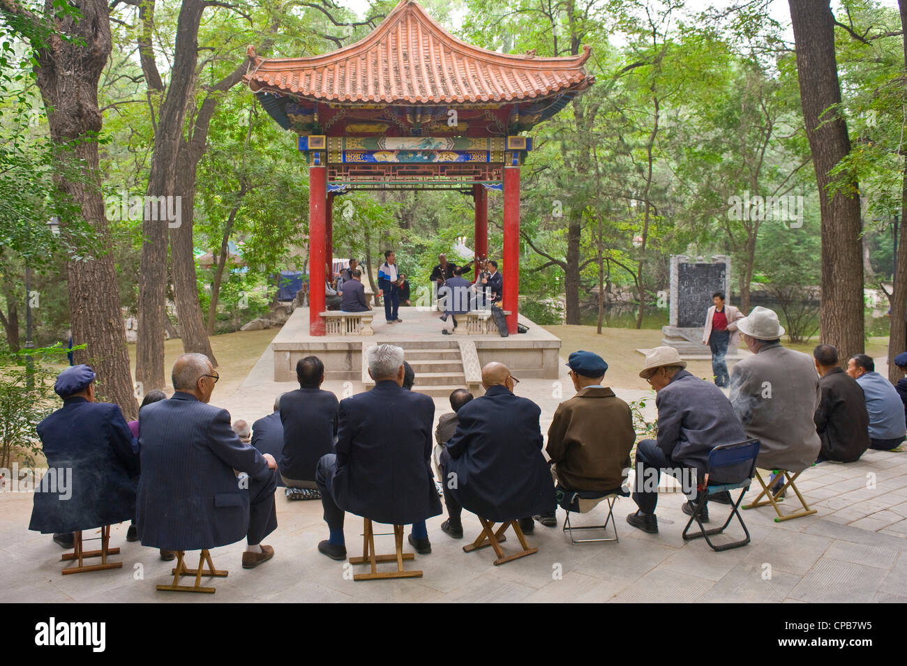 Early morning at a park in Pingliang, Chinese people listen to traditional Chinese music. Stock Photo