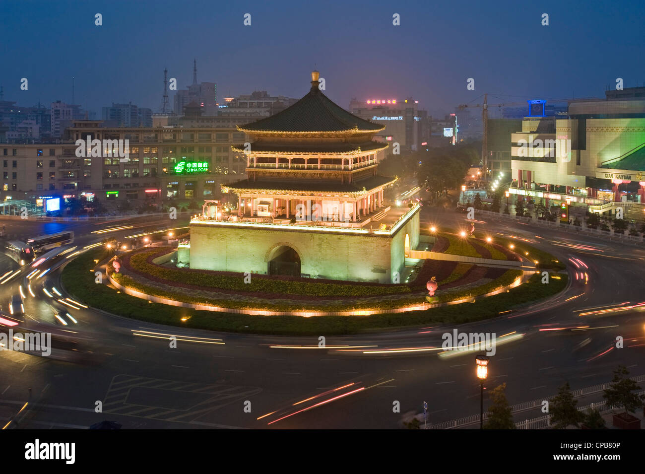 The Bell Tower in Xian with slow shutter speed for motion blur of the traffic at dusk/evening. Stock Photo