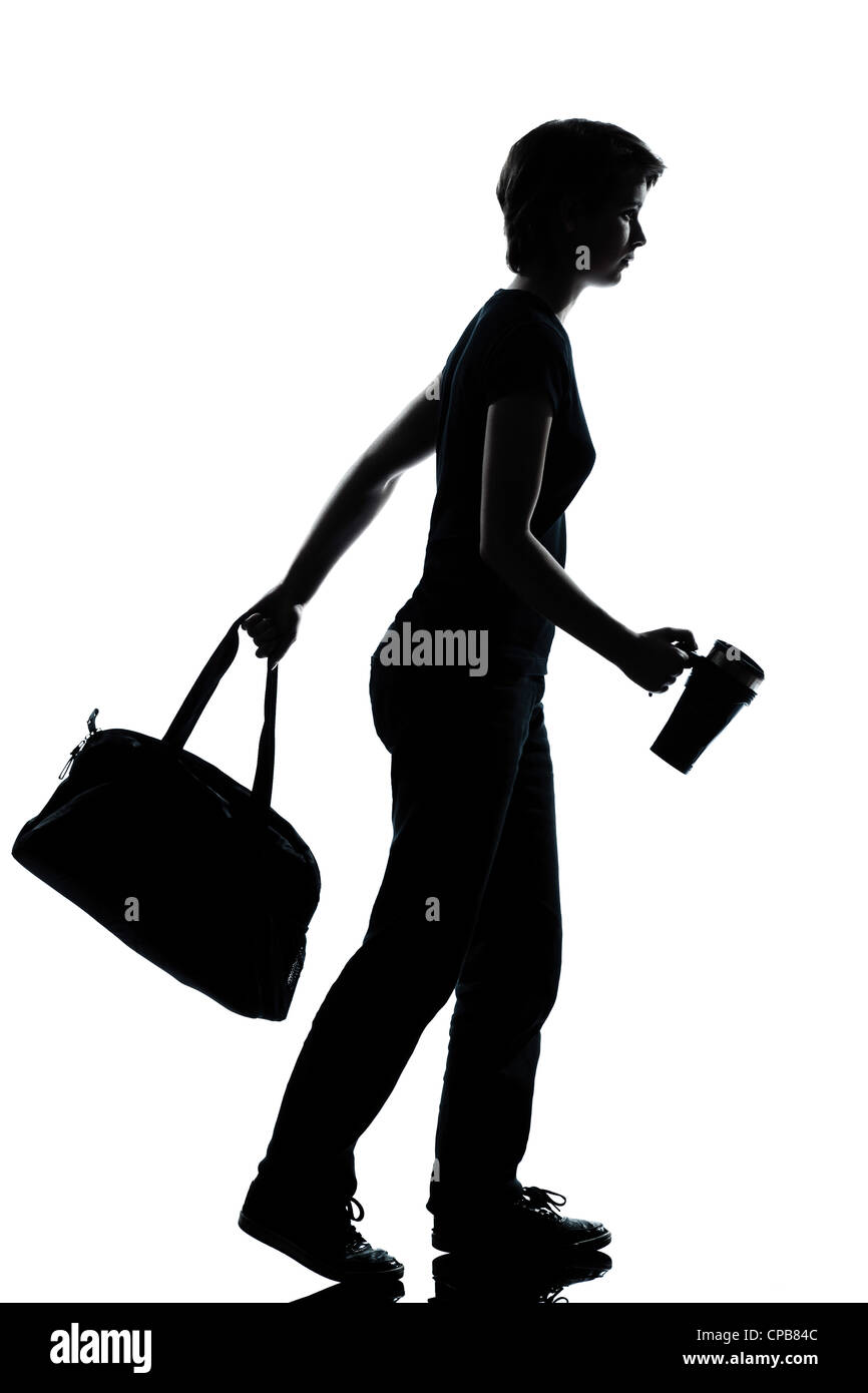 one caucasian young teenager silhouette school girl walking full length in studio cut out isolated on white background Stock Photo