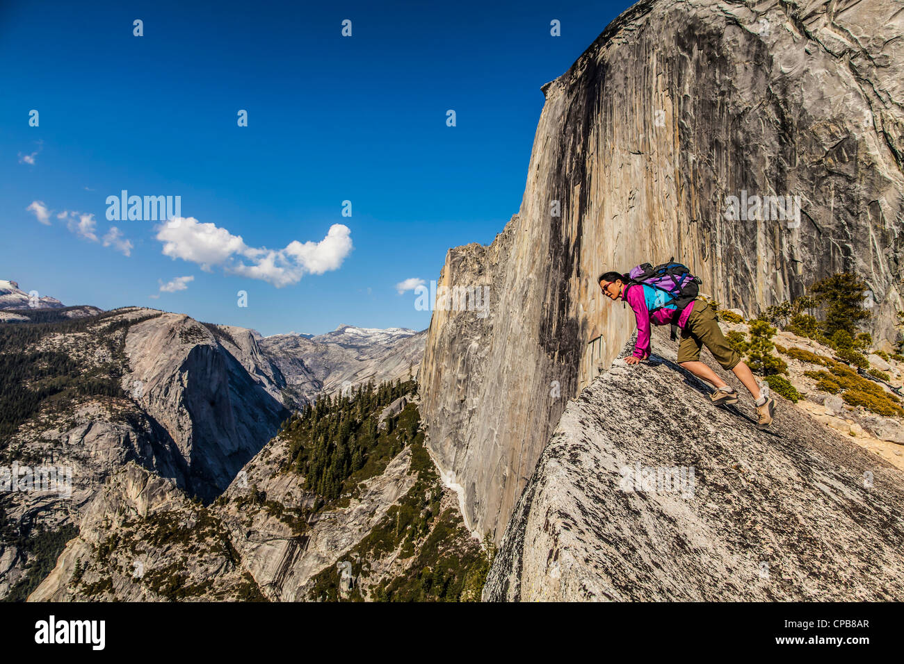 Climber peers over the edge of an abyss in Yosemite National Park. Stock Photo