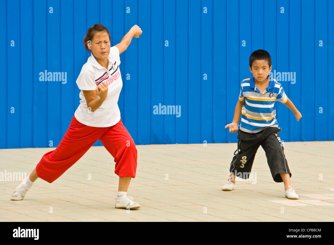 A mother teaching her son Chinese martial arts. Stock Photo