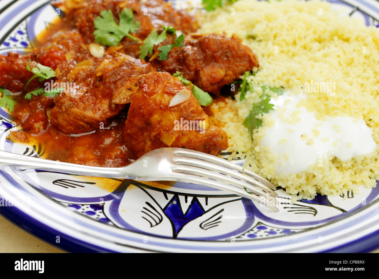A meal of chicken tagine stew in a spicy, nutty tomato sauce, served