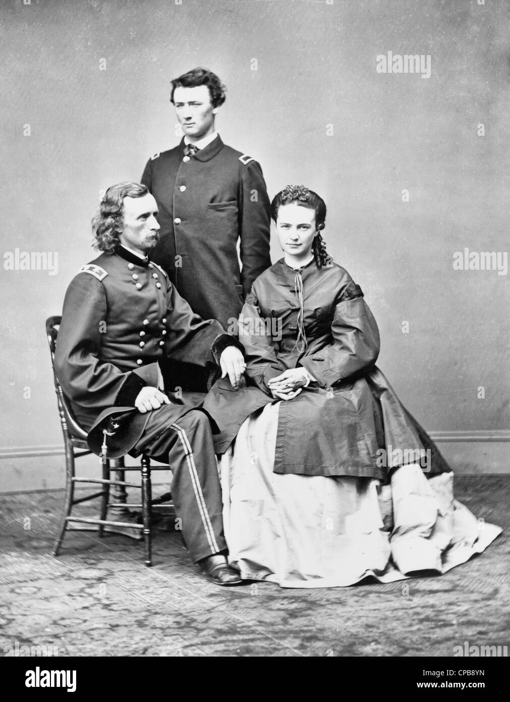 George Armstrong Custer, in uniform, seated with his wife, Elizabeth 'Libbie' Bacon Custer, and his brother, Thomas W. Custer, standing, Circa 1870 Stock Photo