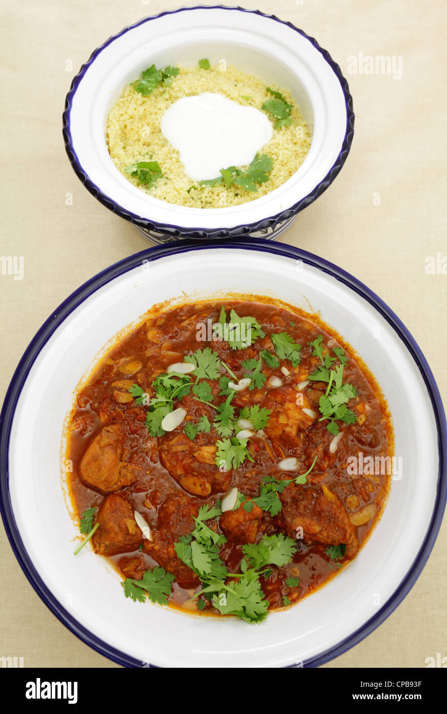 A meal of chicken tagine stew in a spicy, nutty tomato sauce, served