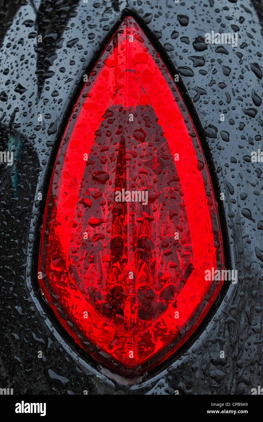 Rear light of a Victory Vegas 8 Ball Motorcycle standing in the rain. Stock Photo
