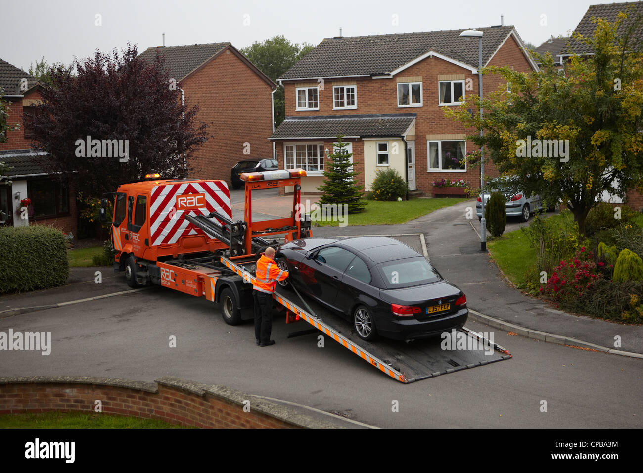 RAC recovery vehicle towing away a broken down car, a BMW Stock Photo
