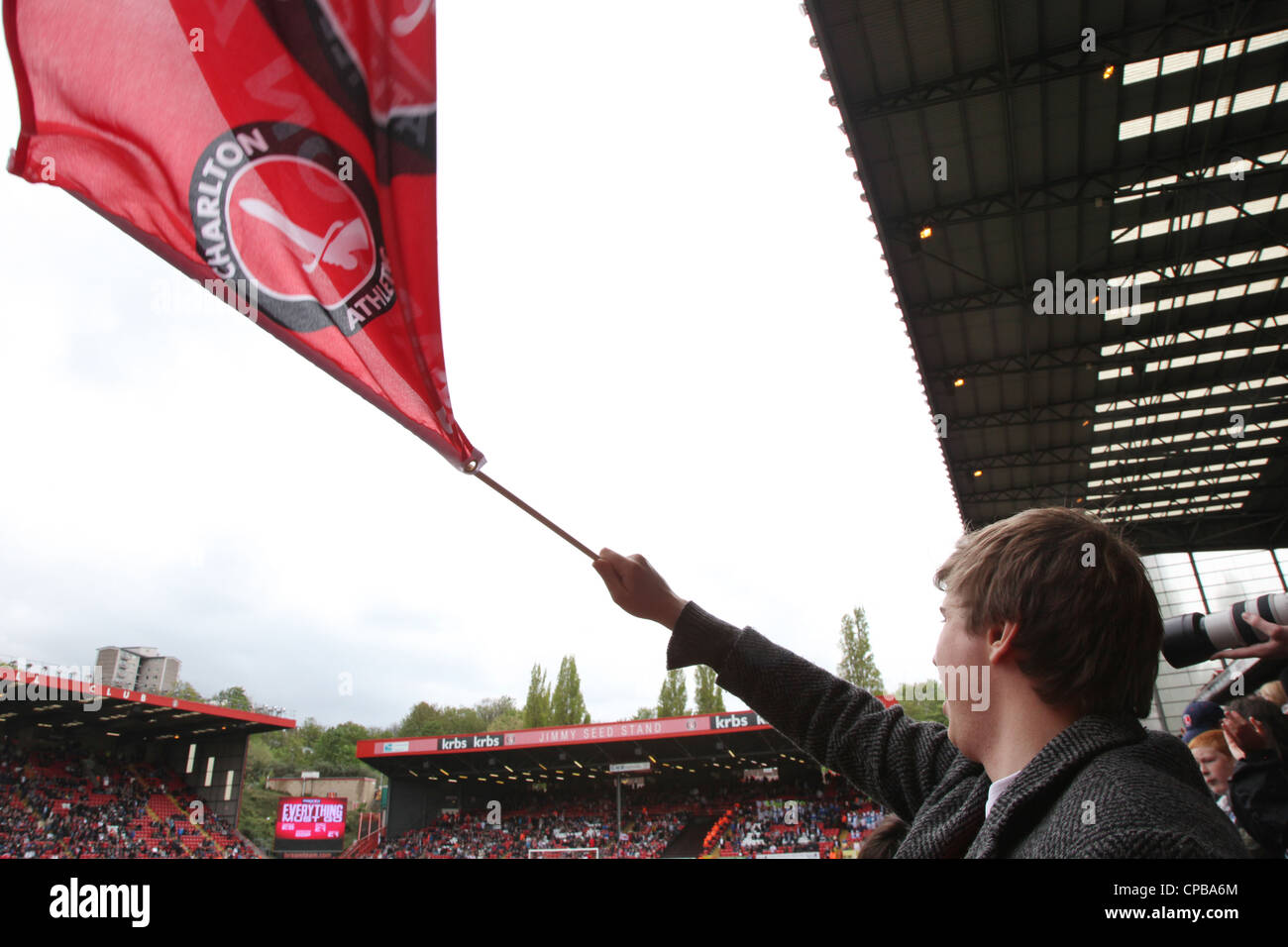 The day Charlton Athletic were crowned champions of league one a fan waves a flag. Stock Photo