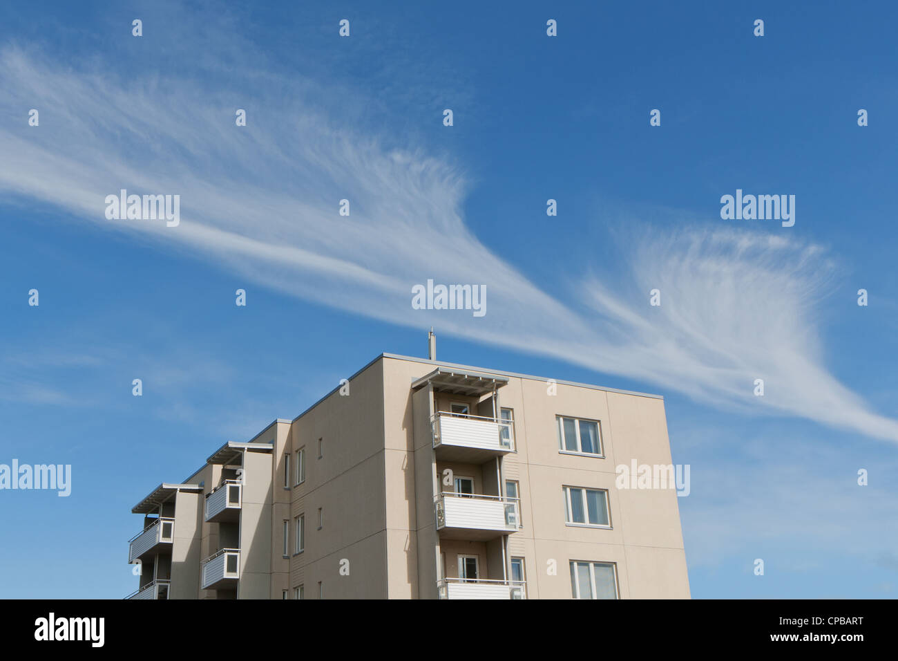 Apartment building and a cloud at blue sky Stock Photo - Alamy