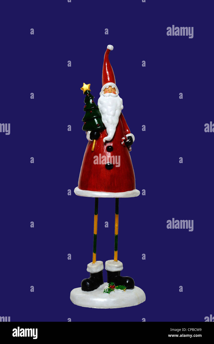 Father Christmas statue against a blue background Stock Photo Alamy