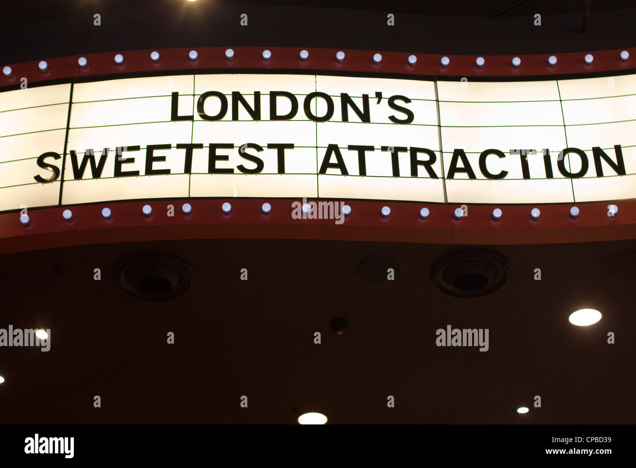 Neon sign with London's sweetest Attraction M&M Store Stock Photo