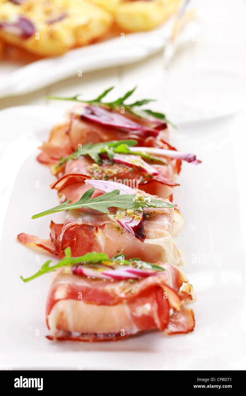 Prosciutto cheese rolls with arugula Stock Photo Alamy