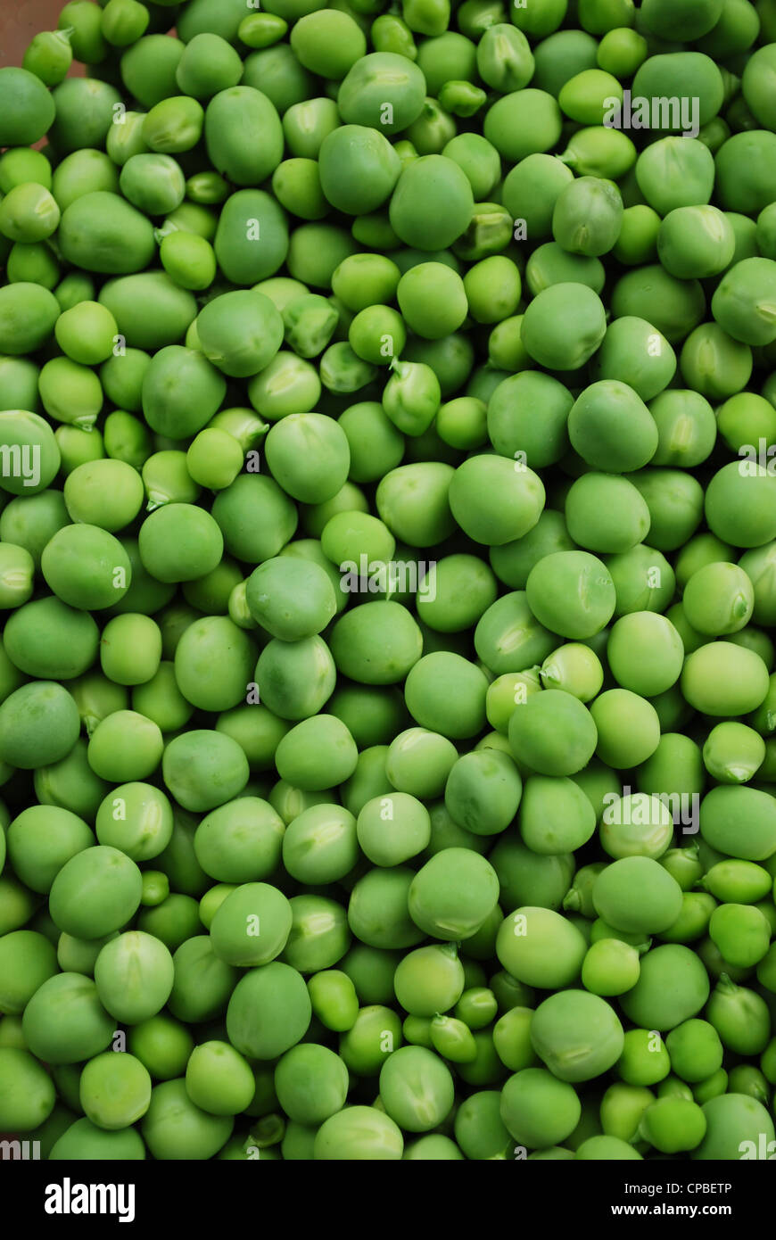 Shelled fresh ripe sweet green peas background Stock Photo