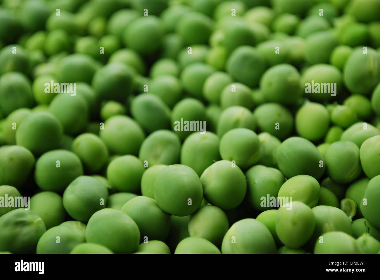 Shelled fresh ripe sweet green peas macro background Stock Photo