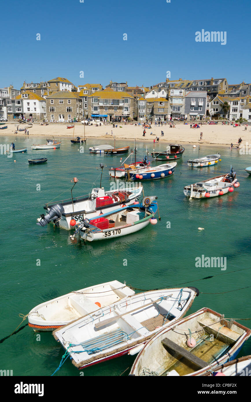 St. Ives habour town beach boats floating on shallow clear sea water, Cornwall UK. Stock Photo