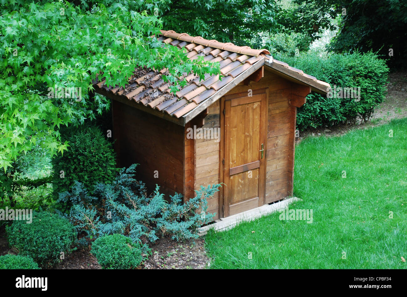 Wooden garden tool shed in a beautiful park Stock Photo Alamy