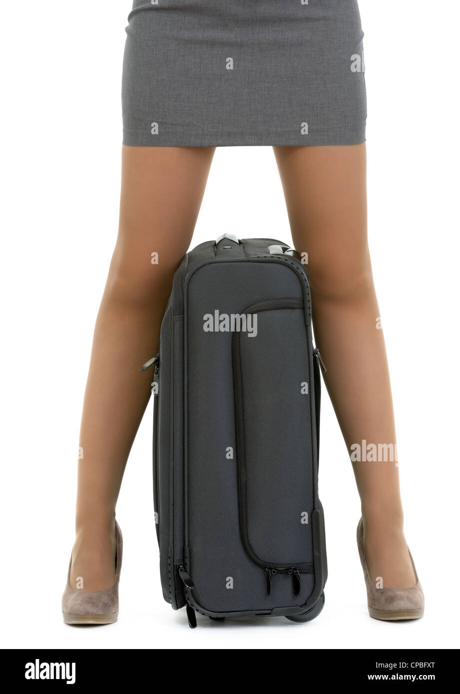 Closeup on suitcase between female legs Stock Photo