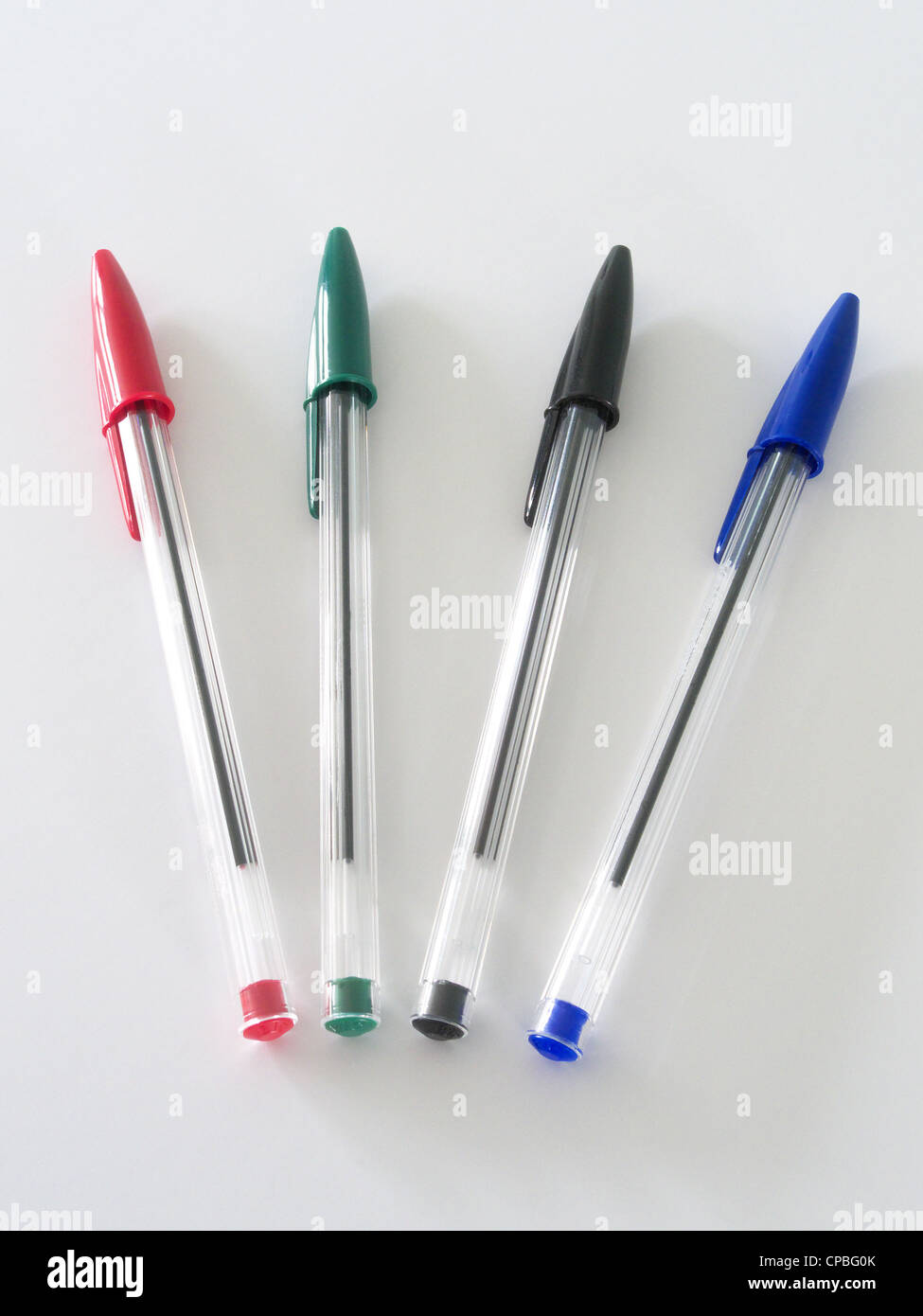 Selection of Red, Green, Black & Blue Crystal Bic Pens on a White Background Stock Photo