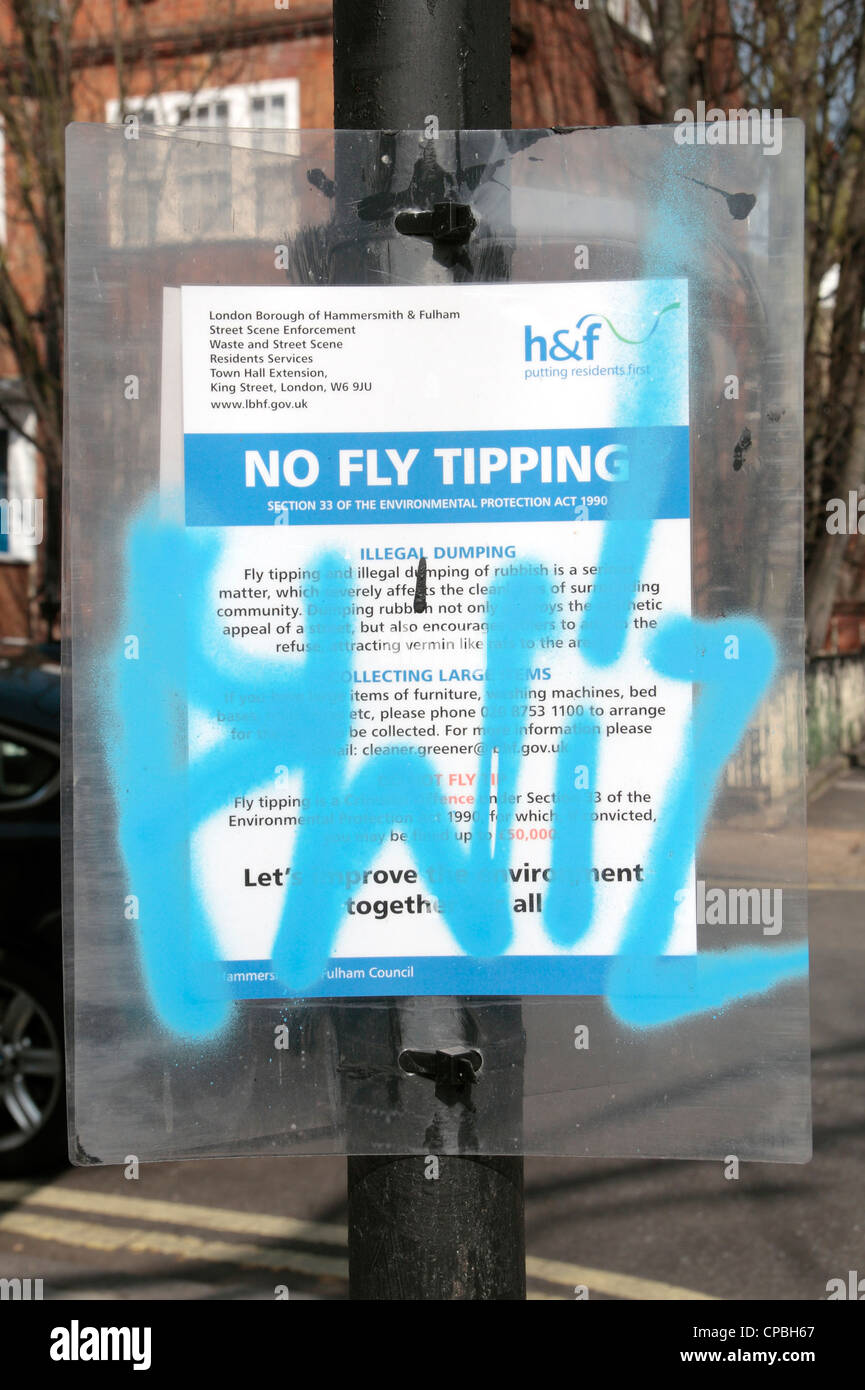 A vandalised 'No Fly Tipping' notice in Fulham, London, UK. Stock Photo