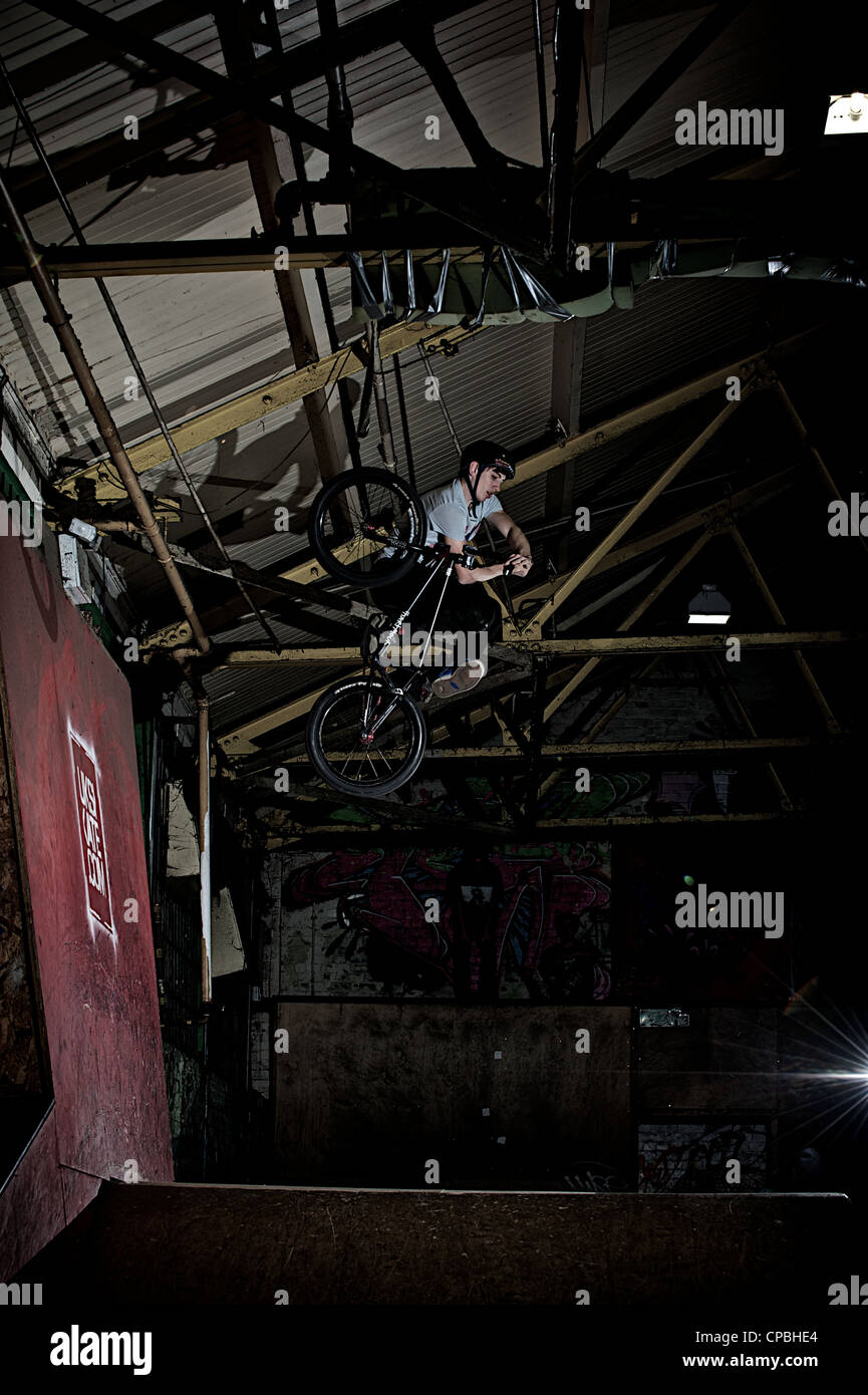 BMX rider performs tricks at an indoor skatepark Stock Photo Alamy
