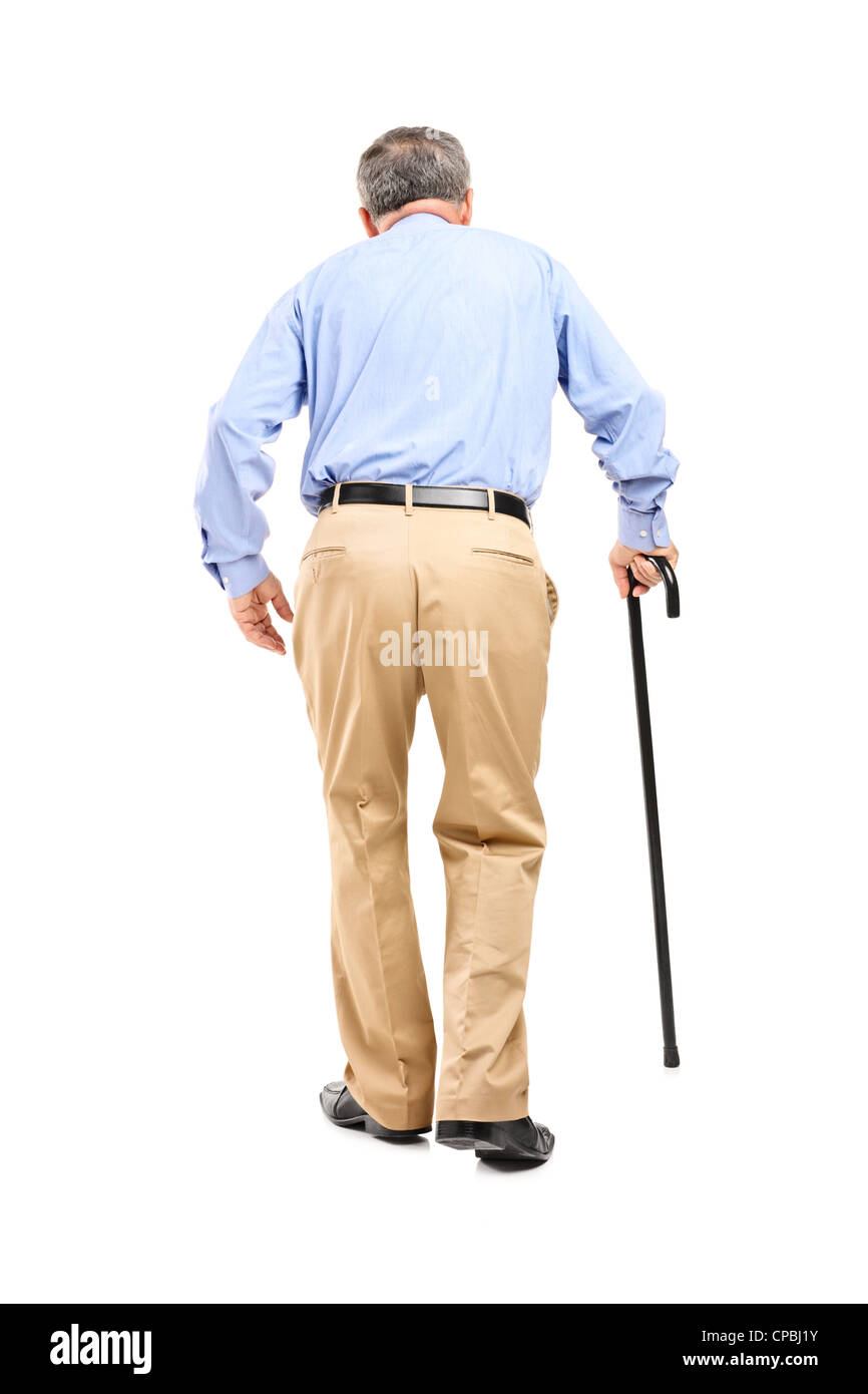 Full length portrait of a senior man with cane walking isolated on white background Stock Photo