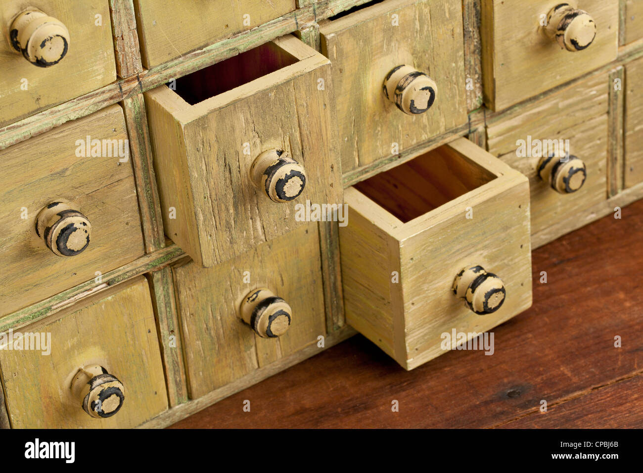 drawers of primitive vintage grunge wood apothecary cabinet Stock Photo
