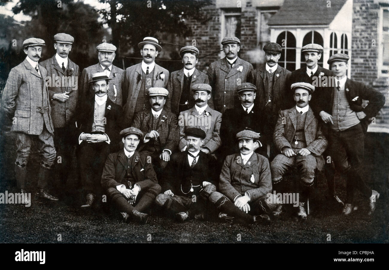 Vintage group portrait of 17 men in Dover, England, wearing various caps, circa 1910. Stock Photo