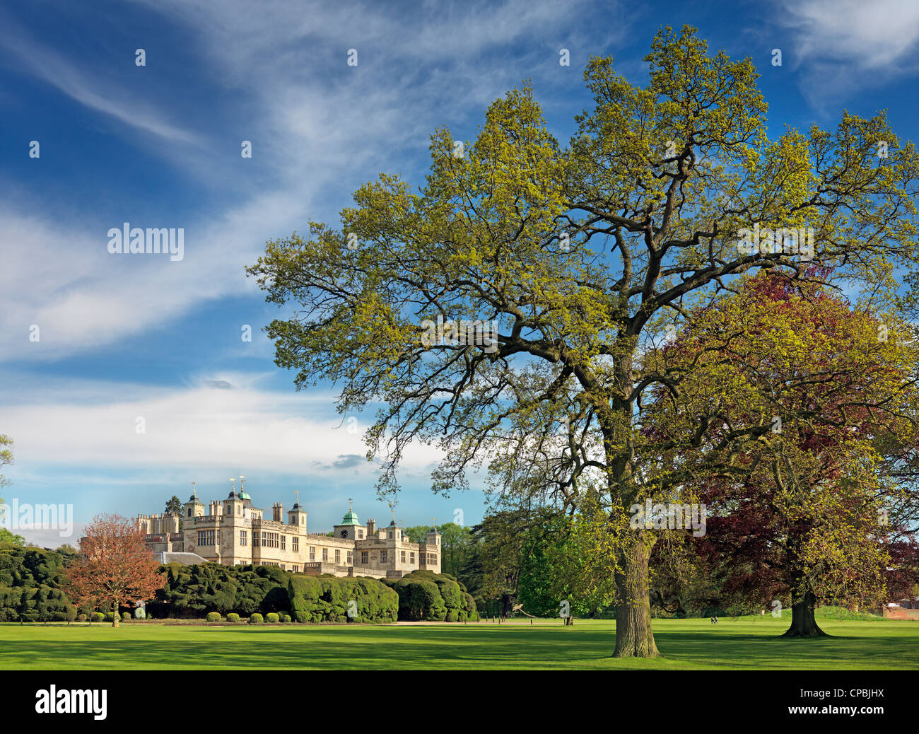 Audley End House framed by parkland trees in Spring Stock Photo