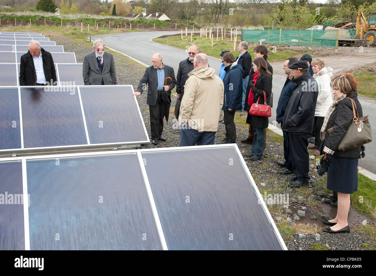 People looking at large solar panels Ireland Stock Photo