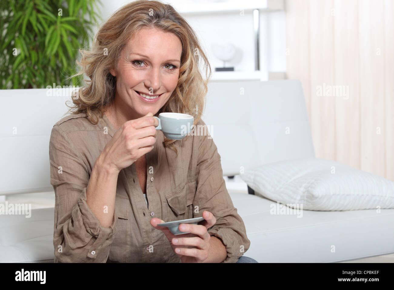 Blonde woman with coffee Stock Photo - Alamy