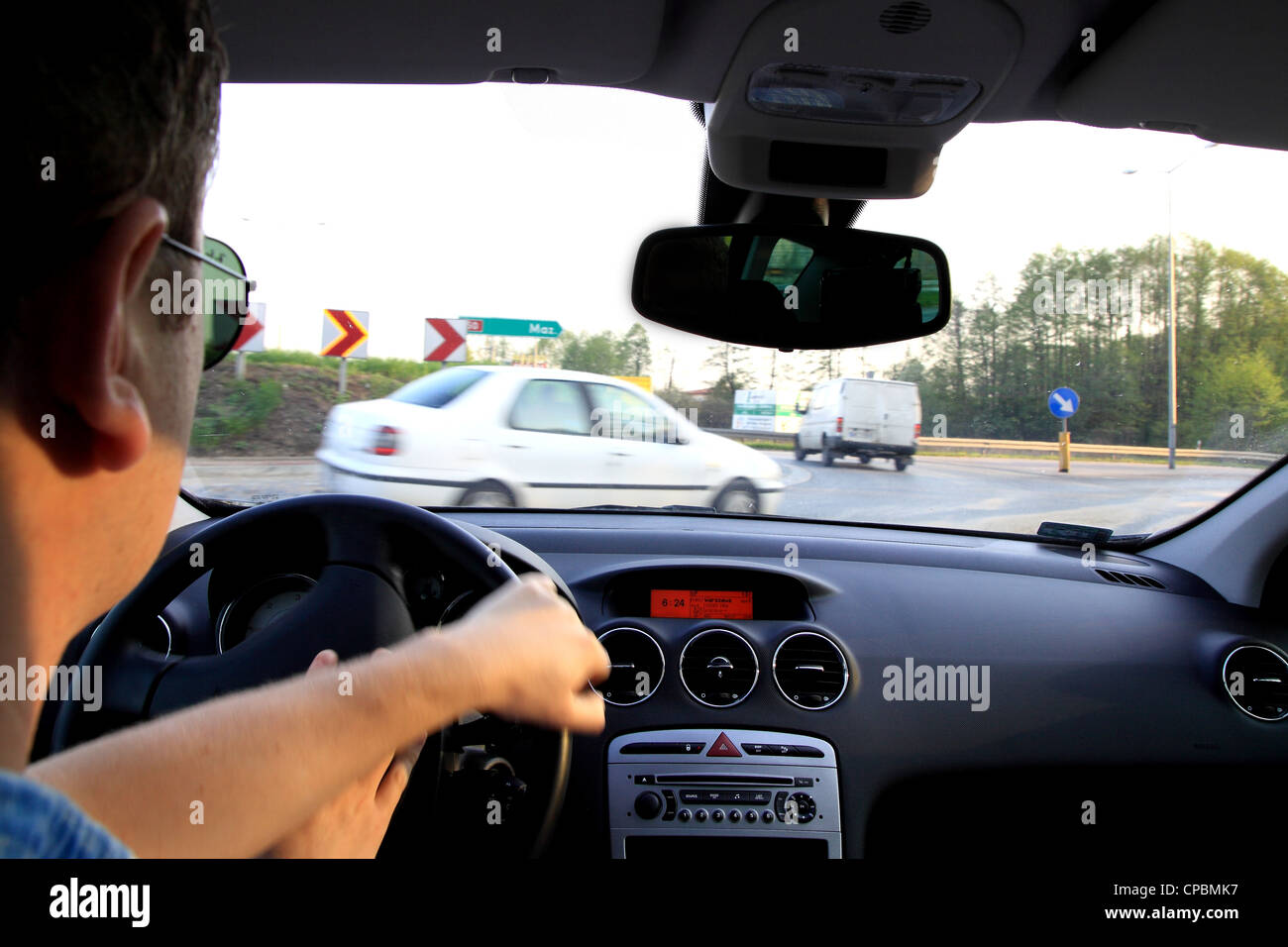 Travelling by car on driver's seat Stock Photo