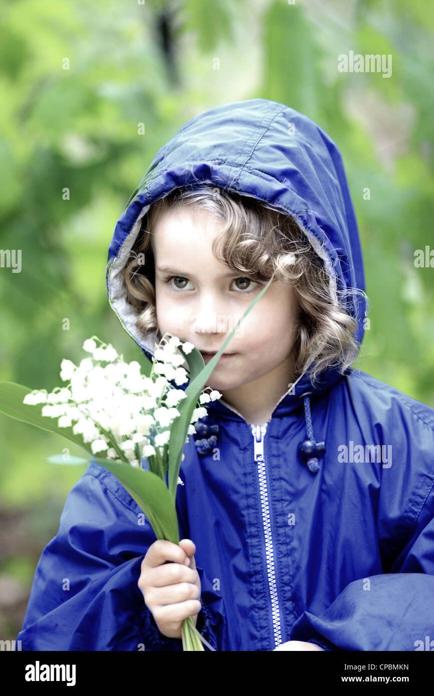 Lovely girl with a bouquet of lily of the valley Stock Photo - Alamy