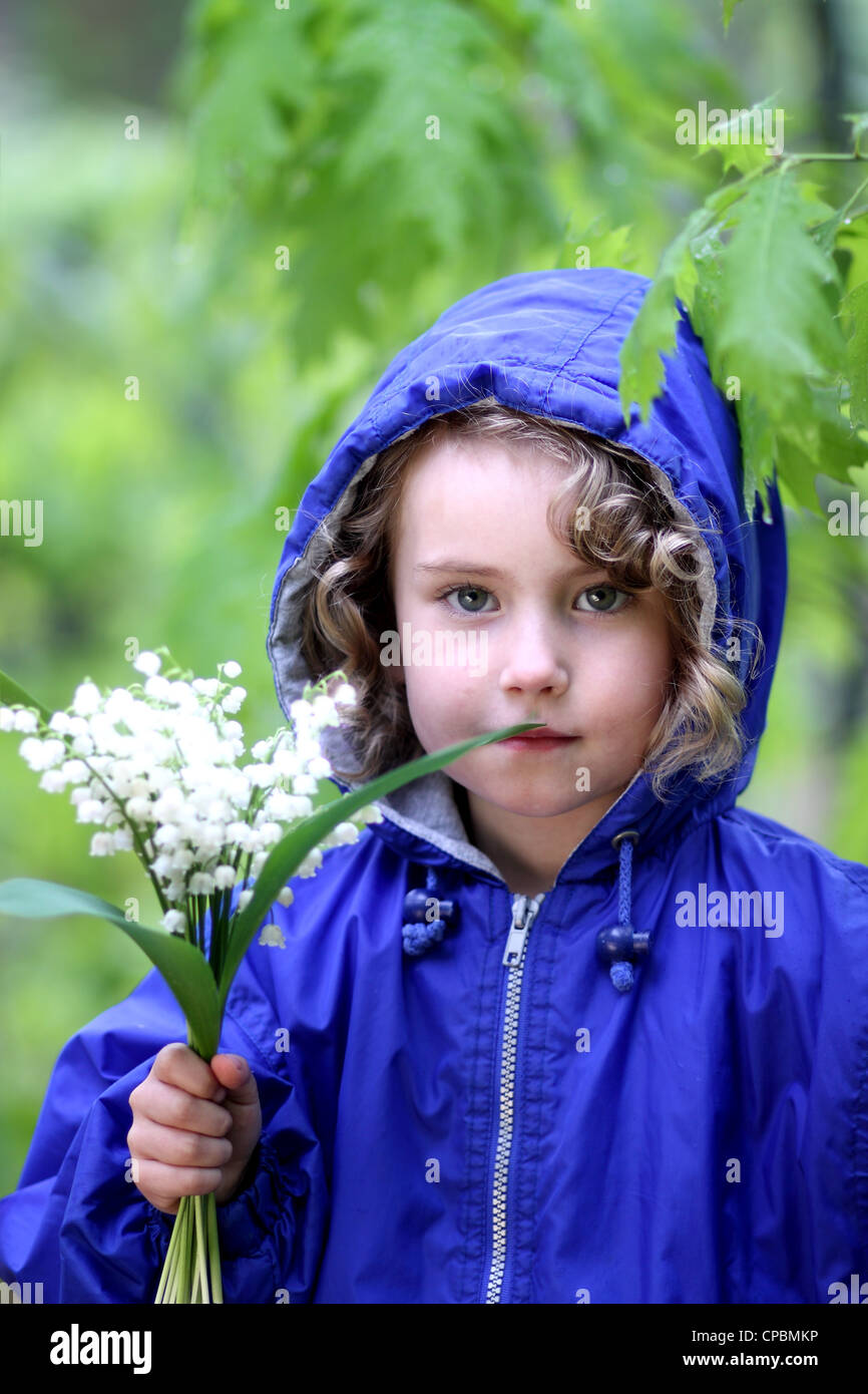Lovely girl with a bouquet of lily of the valley Stock Photo - Alamy