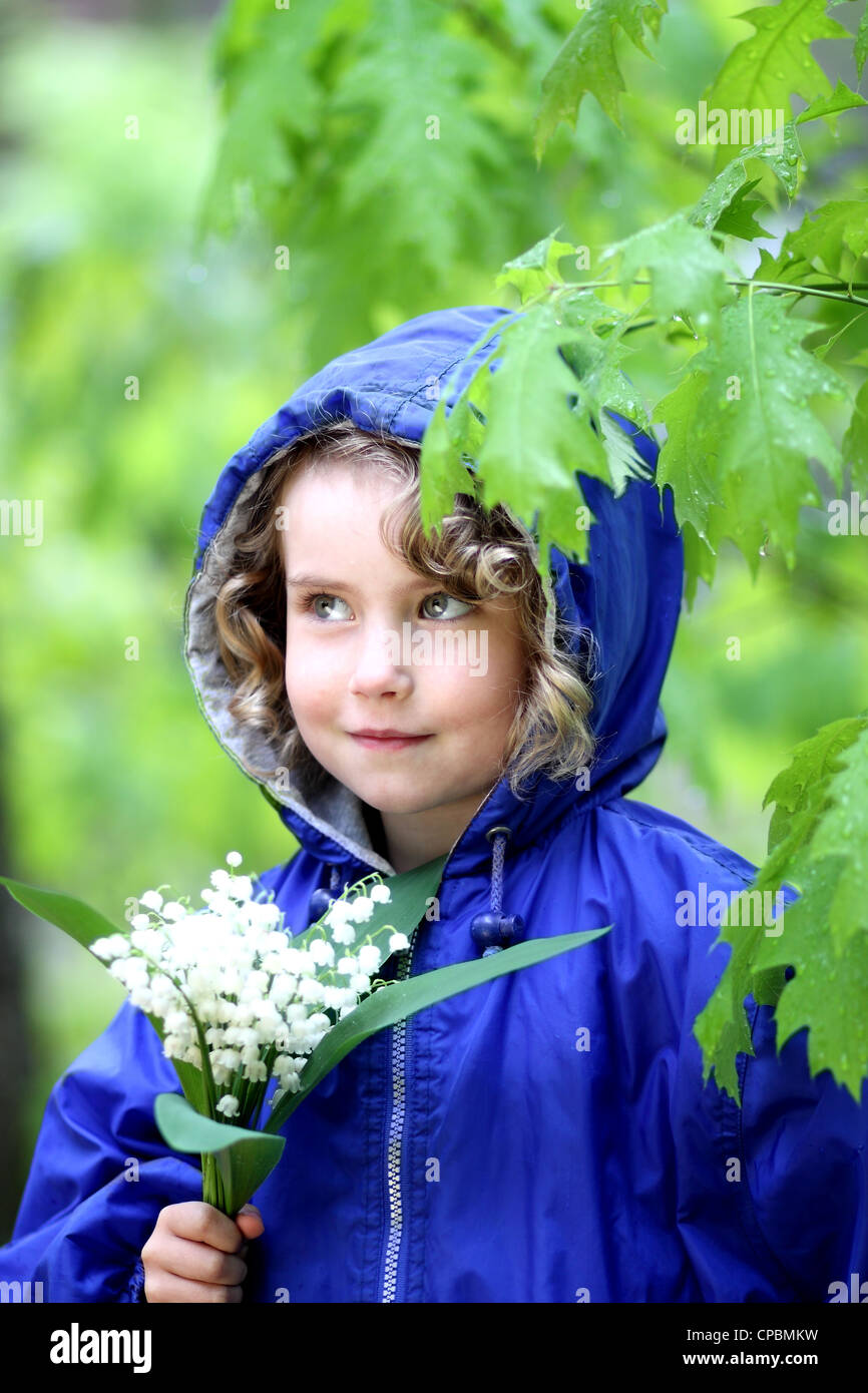 Lovely girl with a bouquet of lily of the valley Stock Photo - Alamy