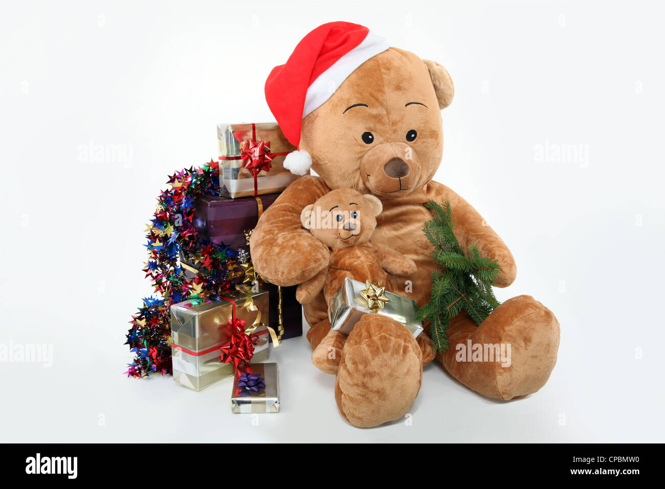 Huge teddy bear and Christmas gifts on white background Stock Photo