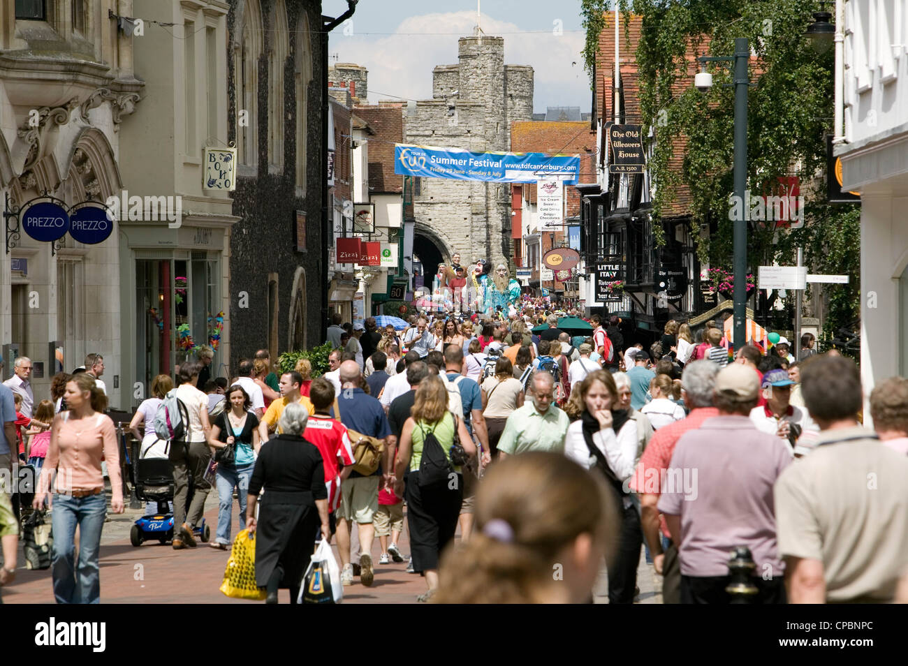 Giants in Canterbury High Street Kent England UK looking towards Westgate Towers Stock Photo