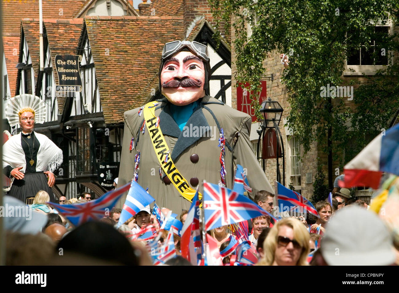 Harry the Hawkinge giants in Canterbury High Street Kent England UK looking towards Westgate Towers Stock Photo