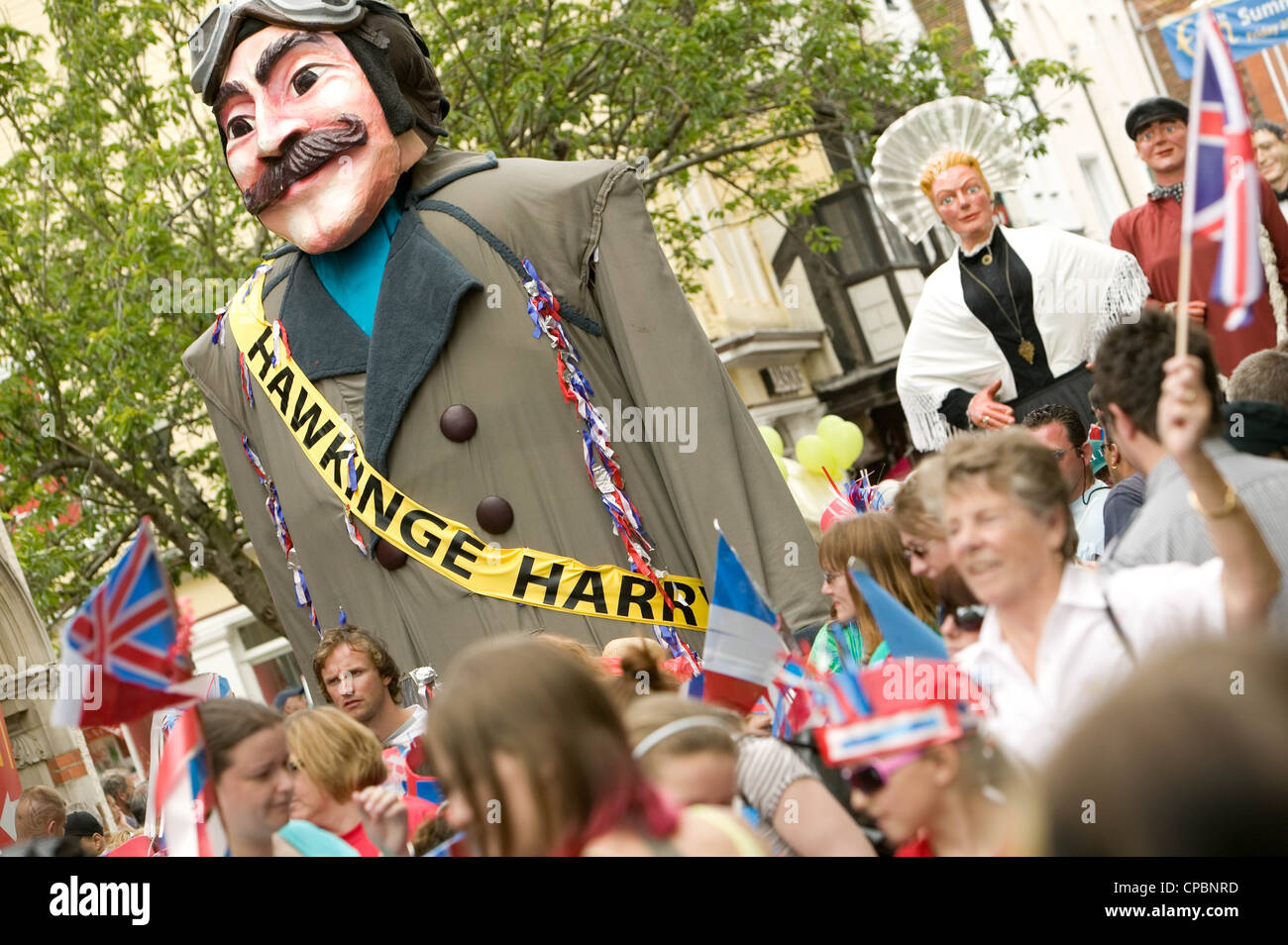 Harry the Hawkinge giants in Canterbury High Street Kent England UK looking towards Westgate Towers Stock Photo