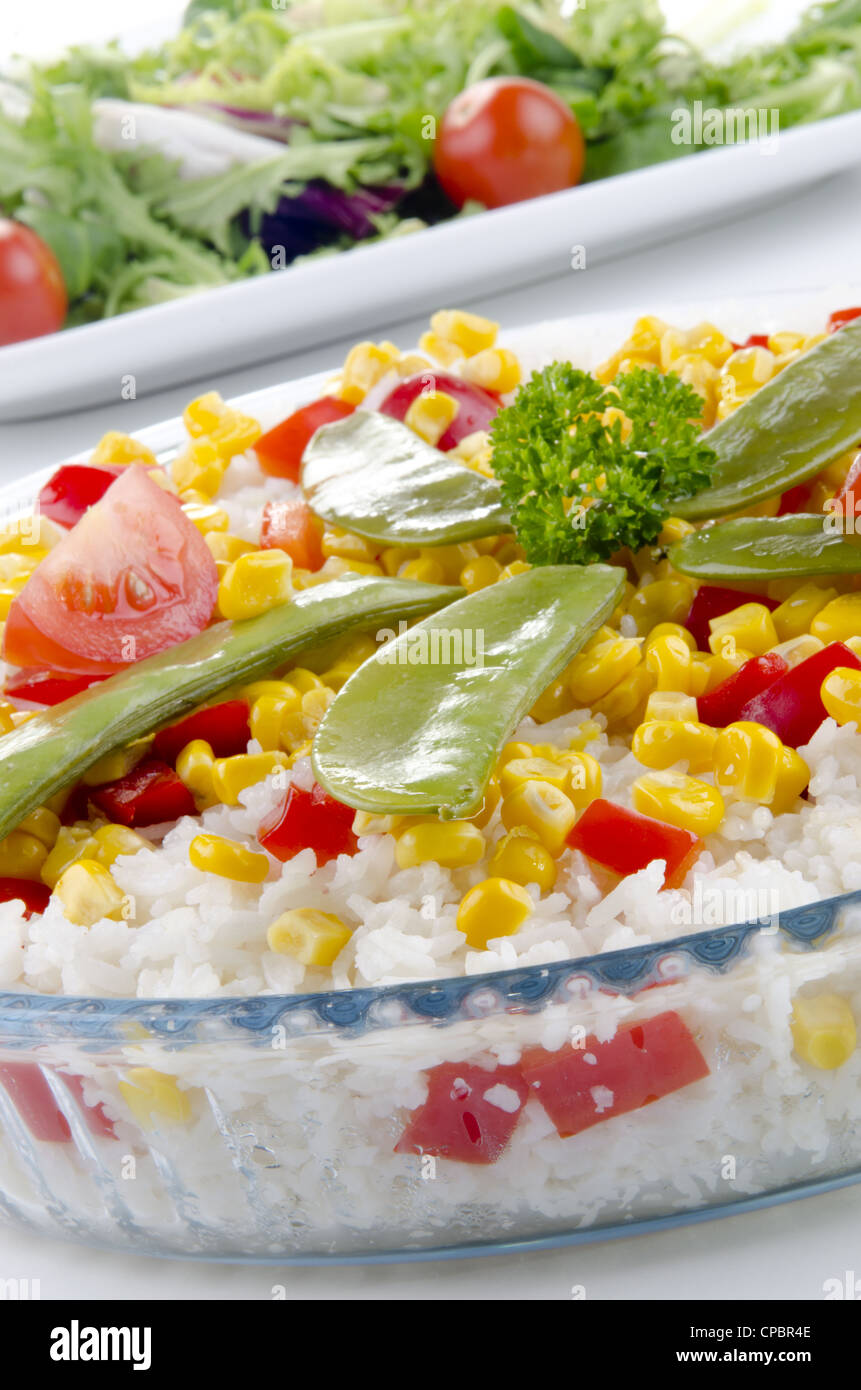 organic rice in a bowl with diced peppers, sweet corn and mangetout Stock Photo