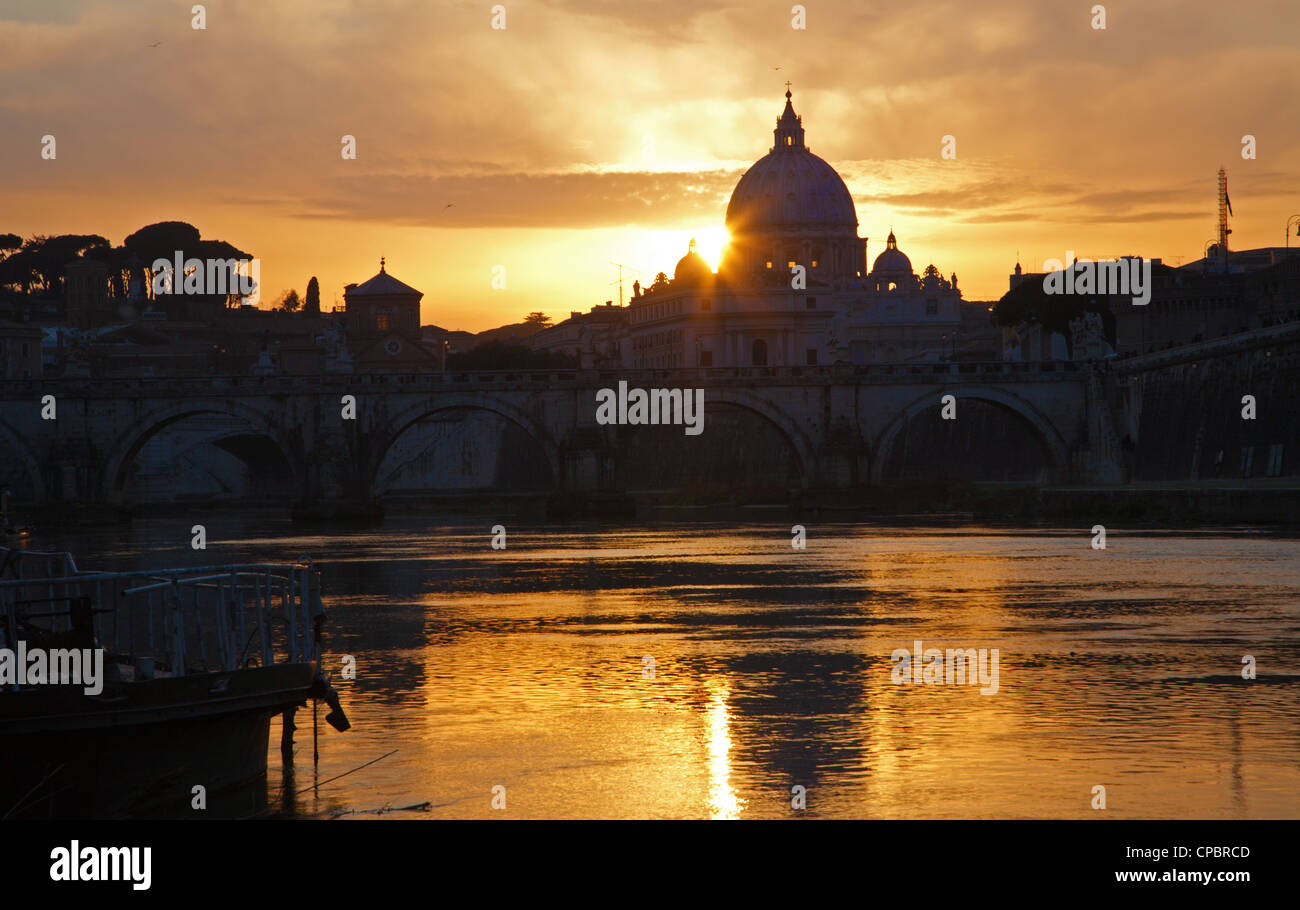 Rome - sunset over Angel s bridge and st. Peter s basilica - Tiber Stock Photo