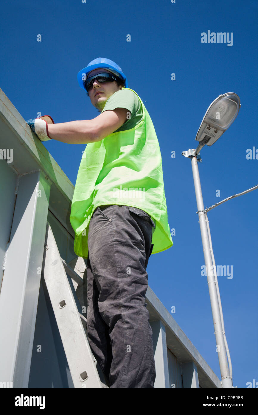 young worker on the ladder Stock Photo