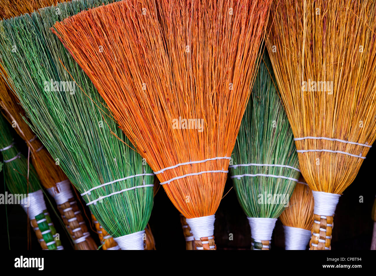 Coloured handmade brooms Stock Photo Alamy