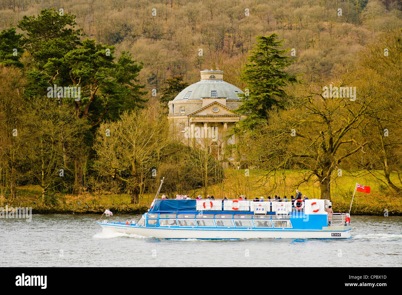 A launch passes the round house on Belle Isle in Windermere Lake District Stock Photo