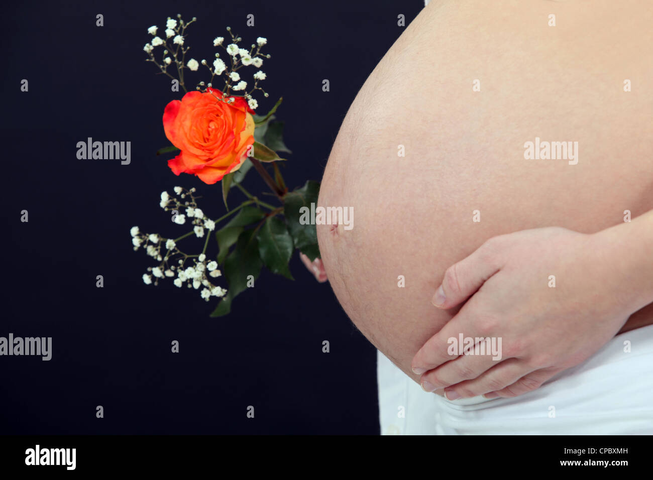 A pregnant woman with a flower. Stock Photo