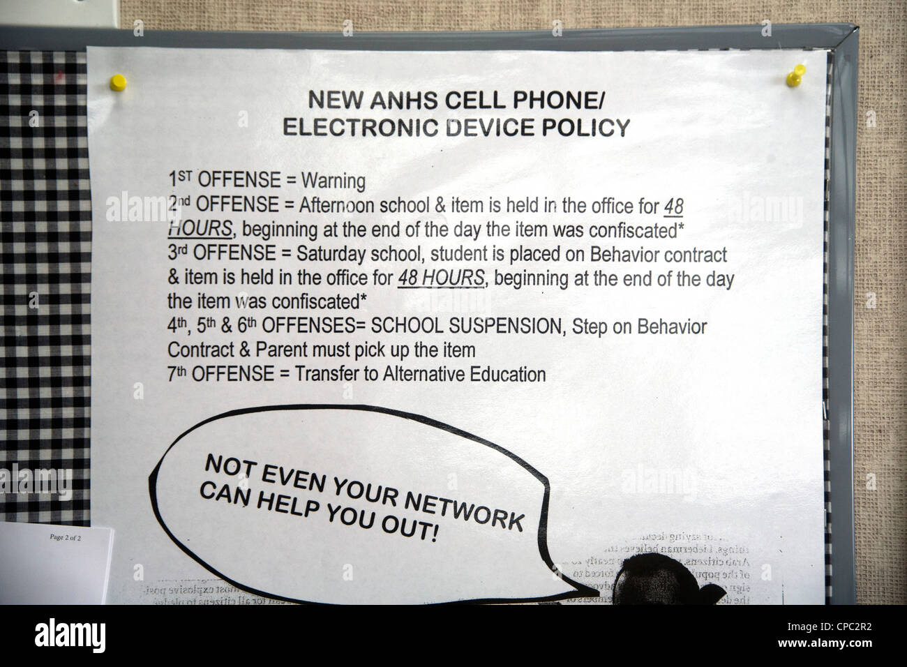 sign on a suburban high school wall in Aliso Viejo, CA, lists escalating penalties for unauthorized use of cell phones. Stock Photo