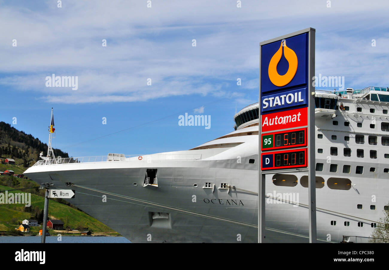 Jokey juxtaposition of a filling station & the P&O cruise ship Oceana docked in Olden, Norway Stock Photo