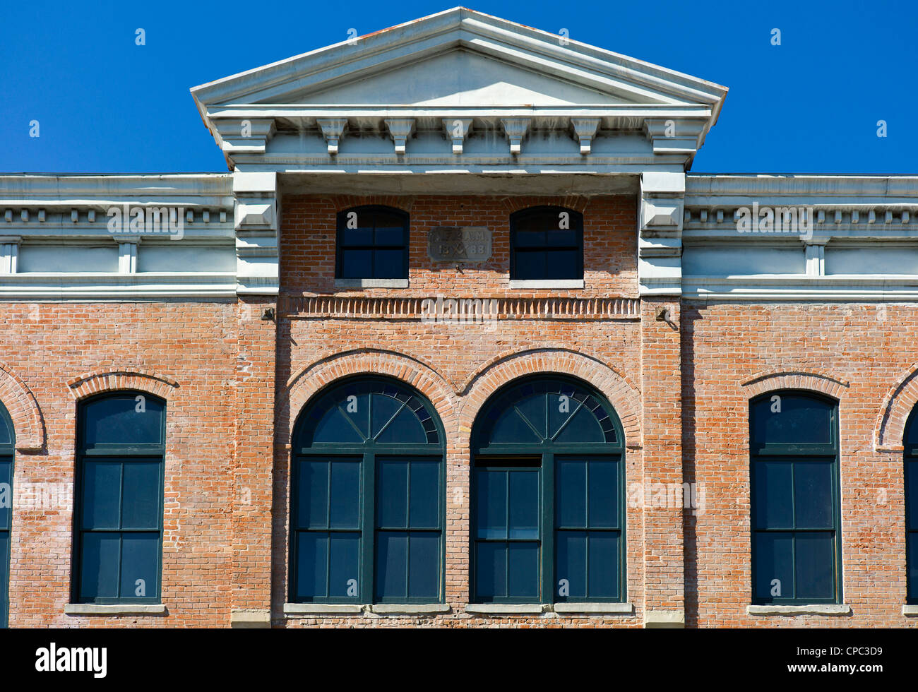 Front facade of the historic Unique Theater in partial decay, Salida