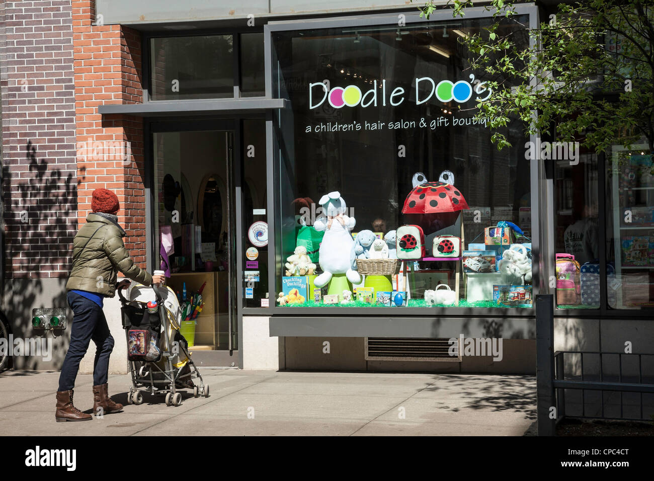 Mother and stroller enter Doodle Doo's children's toy and apparel store