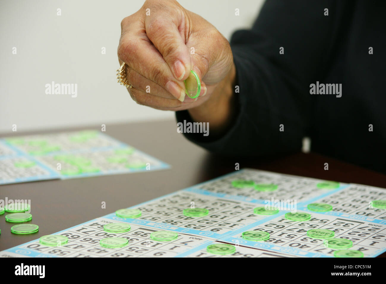 People playing bingo with chips and cards Stock Photo
