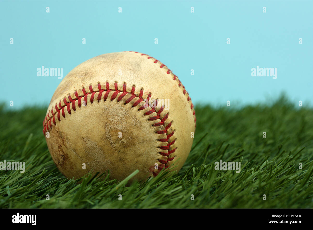 Old Baseball Sitting On A Green Field Stock Photo Alamy