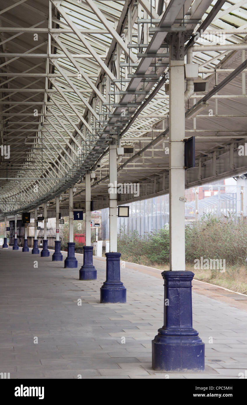 Platform 1 of Bolton railway station, a curved platform with cast iron bases to the steel supporting the canopy. Stock Photo